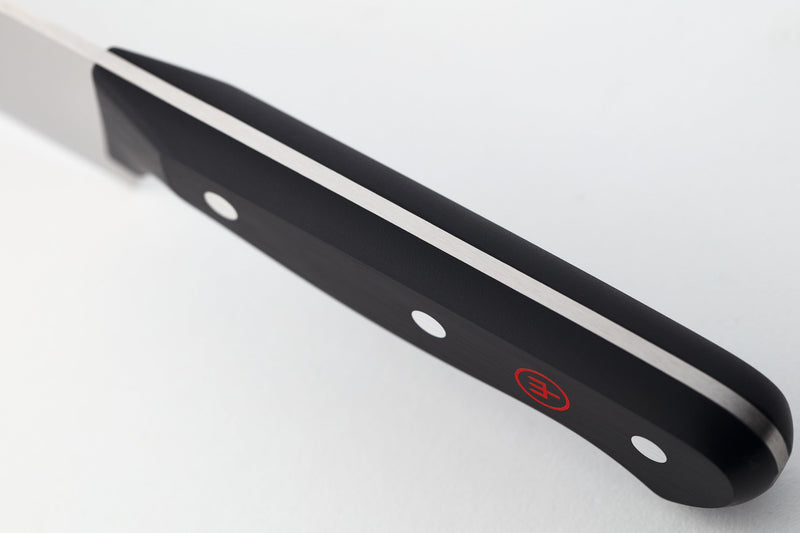 Close-up of a forged kitchen knife with a black ergonomic handle featuring full tang construction and rivets from the Gourmet 16-Piece Knife Block Set.