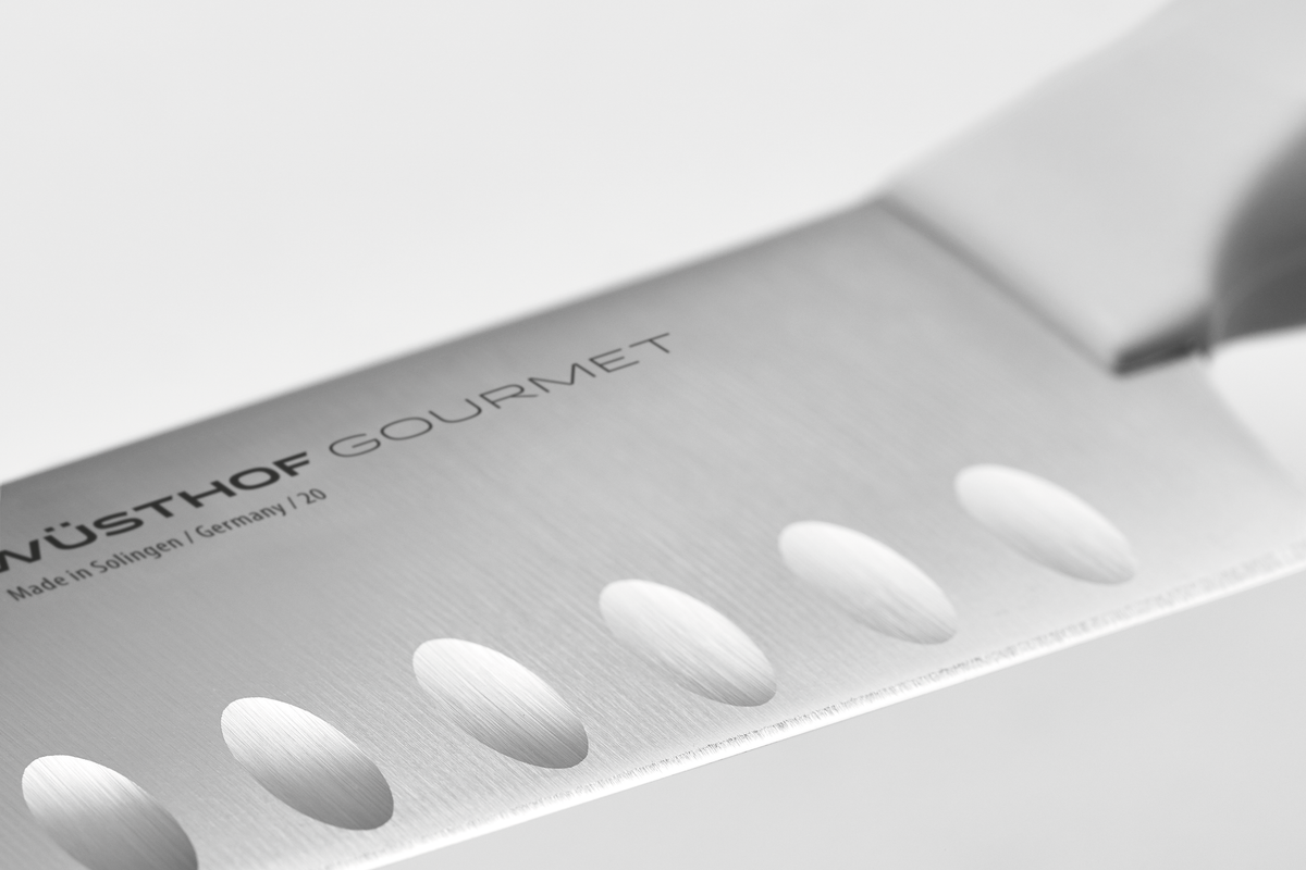 Close-up of a Wüsthof Gourmet knife blade on a white background