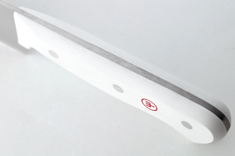 Close-up of the full tang construction and smooth white handle with rivets and red logo from the Gourmet 16-Piece Knife Block Set.