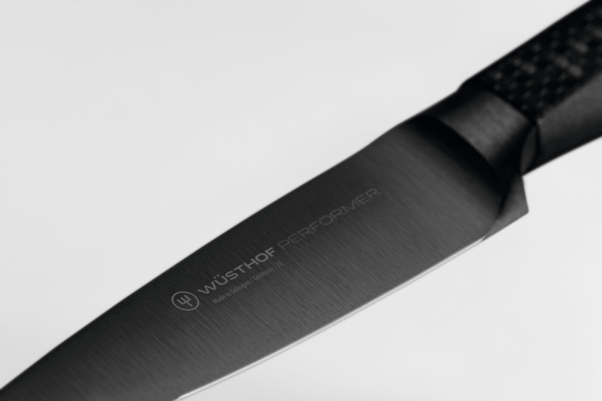 Performer 3 1/2" Paring Knife featuring a sleek black forged German steel blade with WÜSTHOF logo for precise kitchen cutting tasks.