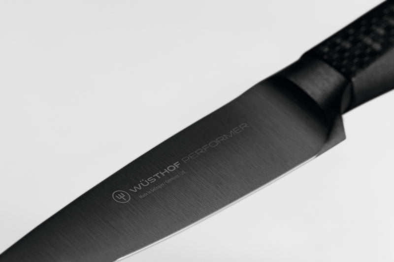 Performer 3 1/2" Paring Knife featuring a sleek black forged German steel blade with WÜSTHOF logo for precise kitchen cutting tasks.
