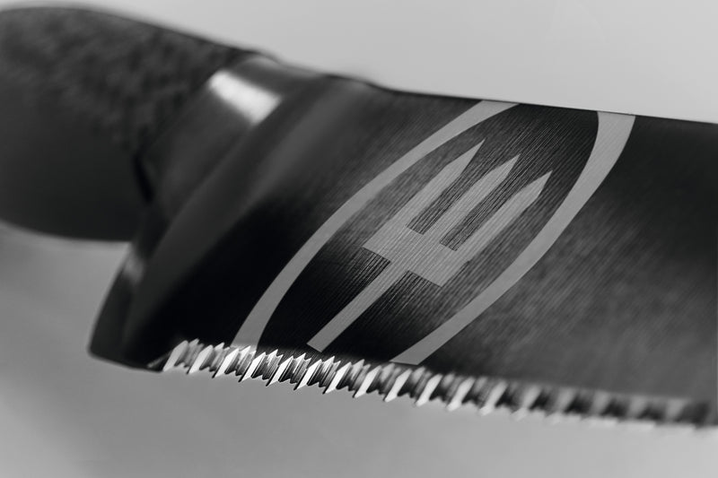 Performer 9" Precision Double-Serrated Bread Knife close-up showing the serrated forged blade with the WÜSTHOF logo and textured ergonomic handle.