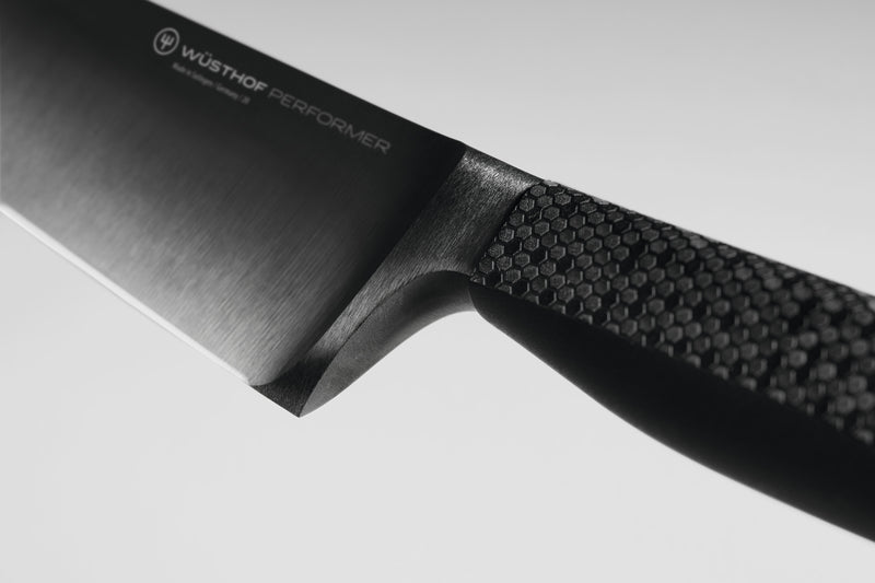 Performer 8" Chef's Knife close-up showing the forged German steel blade with subtle branding and textured ergonomic handle for excellent grip.