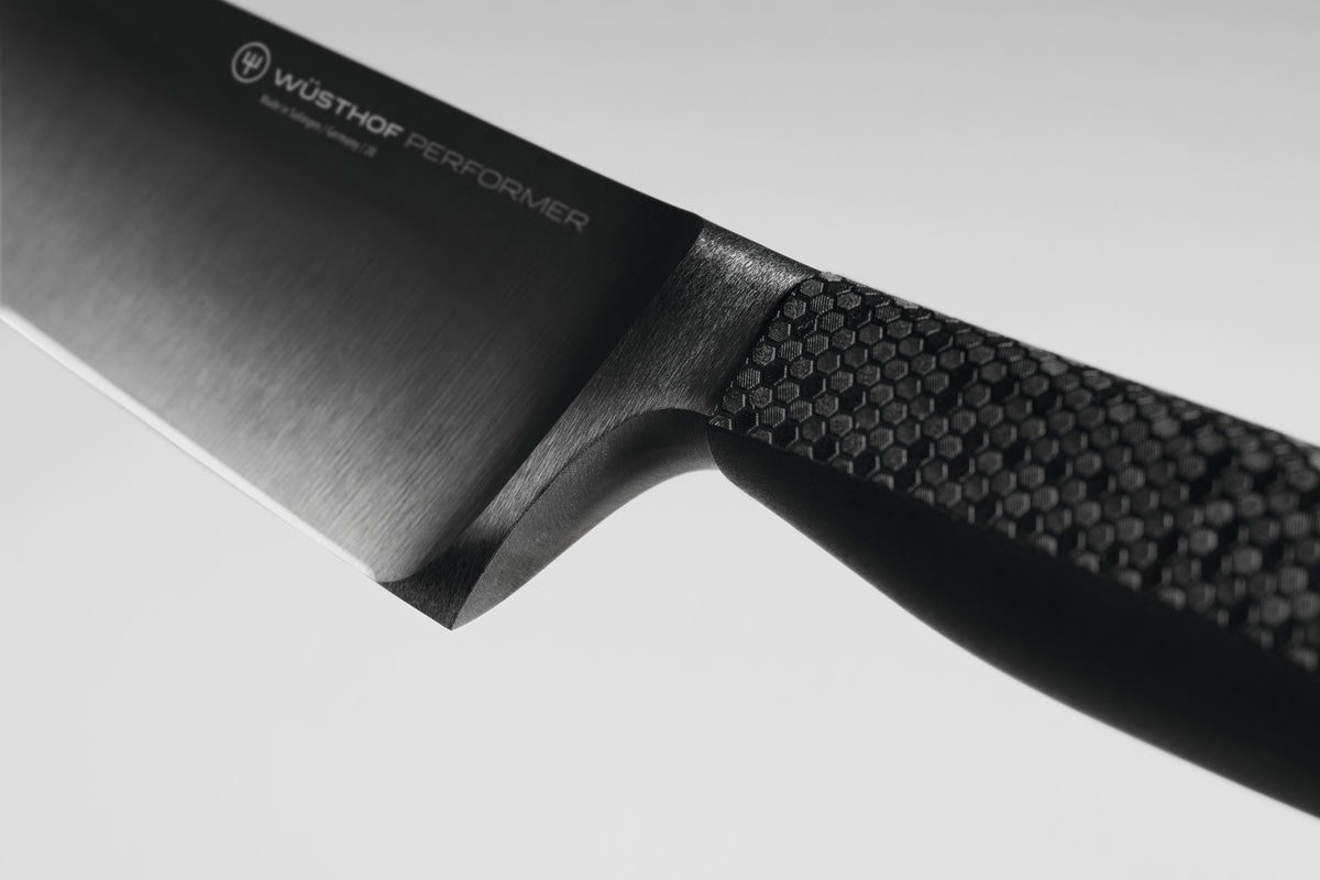 Performer 6" Chef's Knife with a brushed forged German steel blade and textured ergonomic handle designed for precise, balanced cutting.