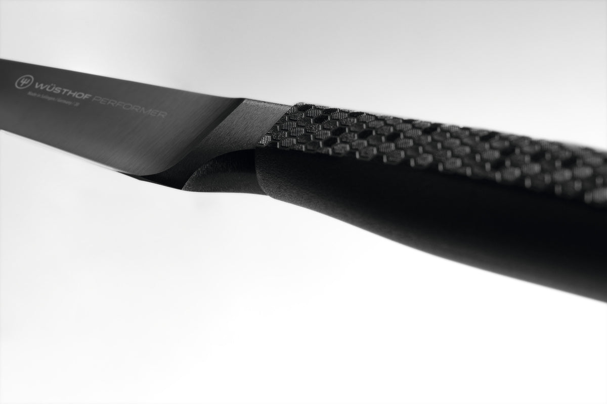Performer 3 1/2" Paring Knife featuring a forged black blade and textured ergonomic handle for precise cutting and optimal control in the kitchen.