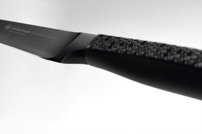 Performer 3 1/2" Paring Knife featuring a forged black blade and textured ergonomic handle for precise cutting and optimal control in the kitchen.