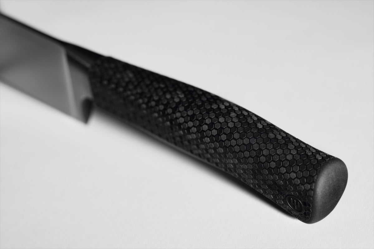 Close-up of the textured ergonomic handle with hexagonal pattern on the Performer 10" Carver designed for secure grip and precision control.