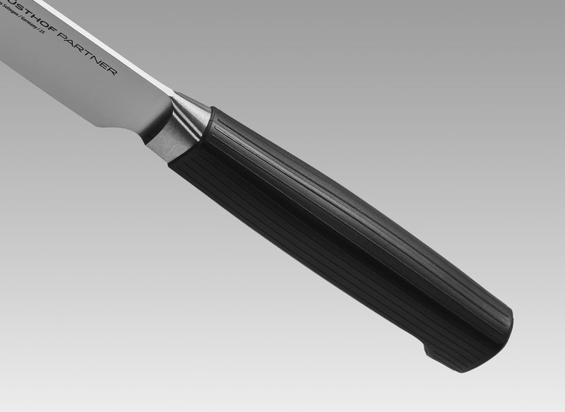 Partner 7-Piece Knife Block Set featuring a close-up of a forged German blade with a textured black ergonomic handle designed for precision and durability.