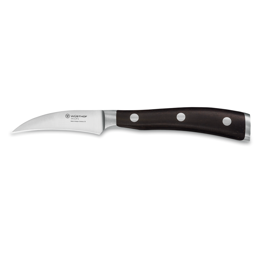 Ikon 3" Peeling Knife with a curved forged German steel blade and a dark triple-riveted wooden handle for precise peeling and detailed kitchen tasks.