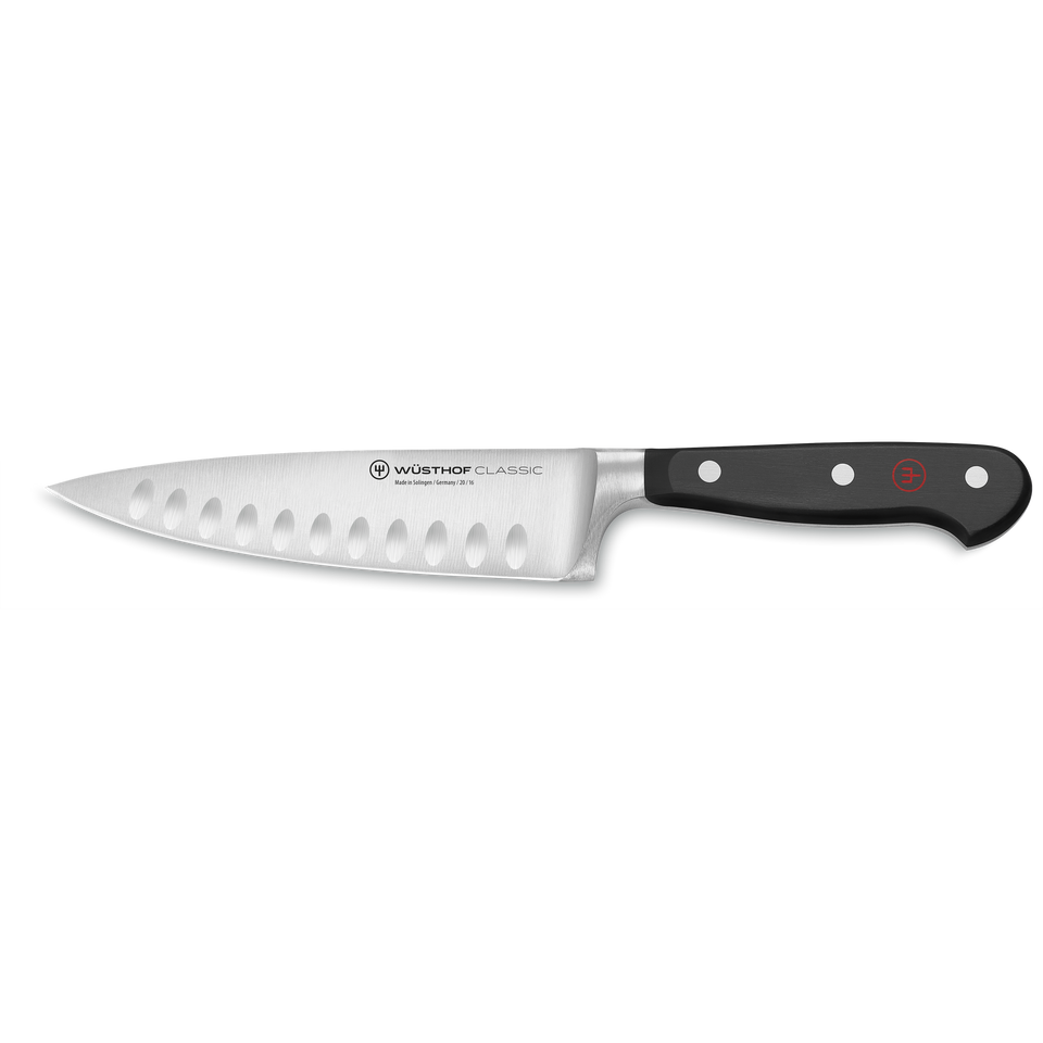 Classic 6" Hollow Edge Chef's Knife featuring a forged stainless steel blade with hollow edges and a triple-riveted black ergonomic handle for precision cutting.