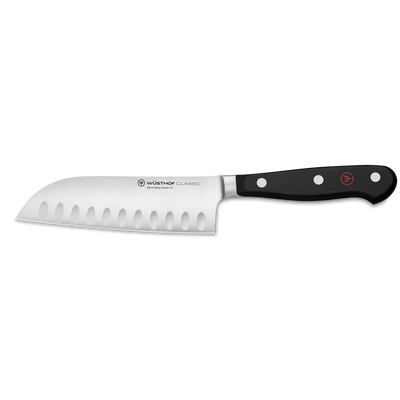 Classic 5" Hollow Edge Santoku featuring a forged stainless steel blade with hollow indentations and a triple-riveted ergonomic black handle for versatile kitchen tasks.