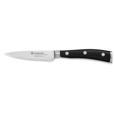 Classic Ikon 3 1/2" Paring Knife with a sharp forged German steel blade and triple-riveted black handle for precise peeling and intricate kitchen tasks.