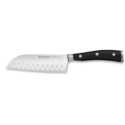 Classic Ikon 5" Hollow Edge Santoku featuring a forged German steel blade with hollowed edges and a triple-riveted black handle for precise kitchen cutting.