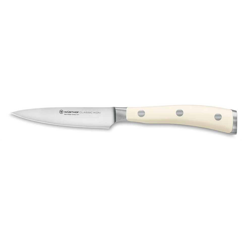 Classic Ikon 3 1/2" Paring Knife with a sharp forged German steel blade and smooth triple-riveted ivory handle for precise kitchen tasks.