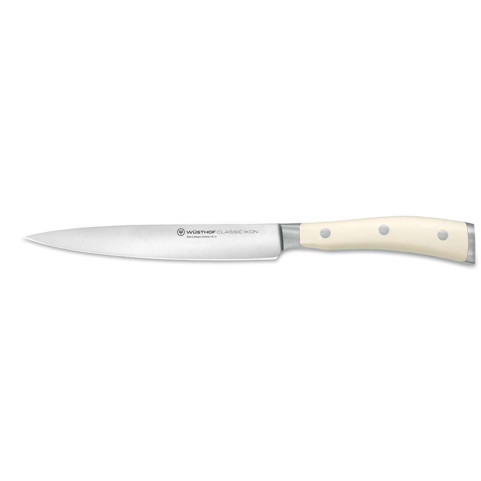 Classic Ikon 6" Utility Knife with a slender forged German steel blade and a smooth triple-riveted ivory handle for precise kitchen cutting tasks.