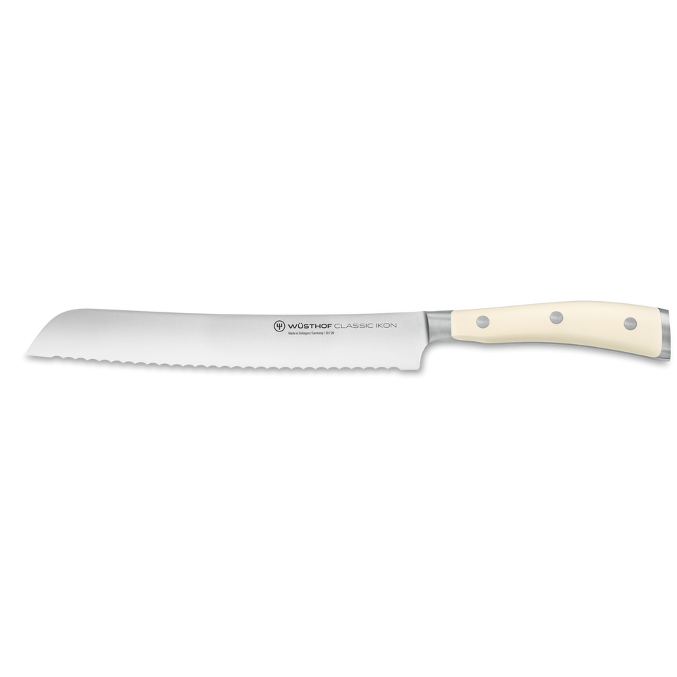 Classic Ikon 8" Bread Knife with a serrated forged German steel blade and a smooth ivory triple-riveted handle for precise bread cutting.