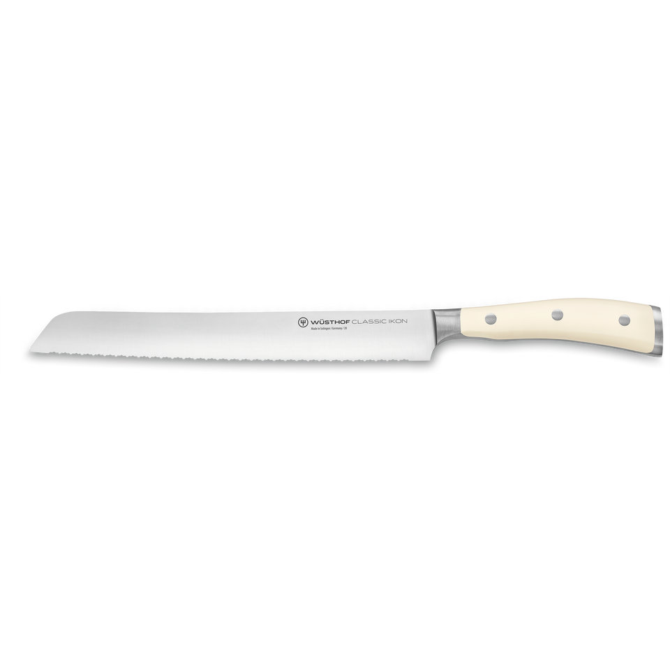 Classic Ikon 9" Precision Double-Serrated Bread Knife with a long forged German steel blade and smooth ivory triple-riveted handle for precise slicing.