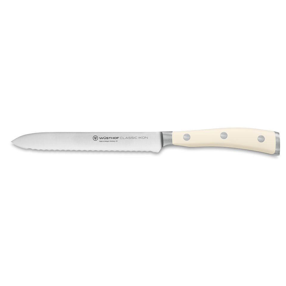 Classic Ikon 5" Serrated Utility Knife with a finely forged German steel blade and smooth triple-riveted ivory handle for precise cutting tasks.