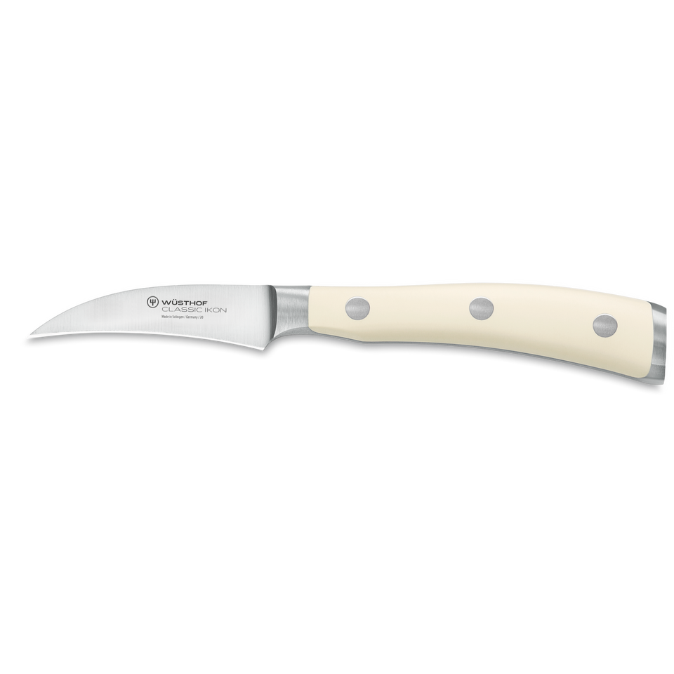 Classic Ikon 2 3/4" Peeling Knife with a curved, finely forged German steel blade and an ivory triple-riveted handle for precise peeling and trimming tasks.