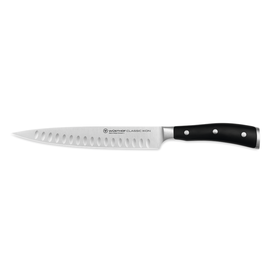 Classic Ikon 8" Hollow Edge Carving Knife with a German-forged blade featuring hollow indentations and a triple-riveted black ergonomic handle for precise slicing.