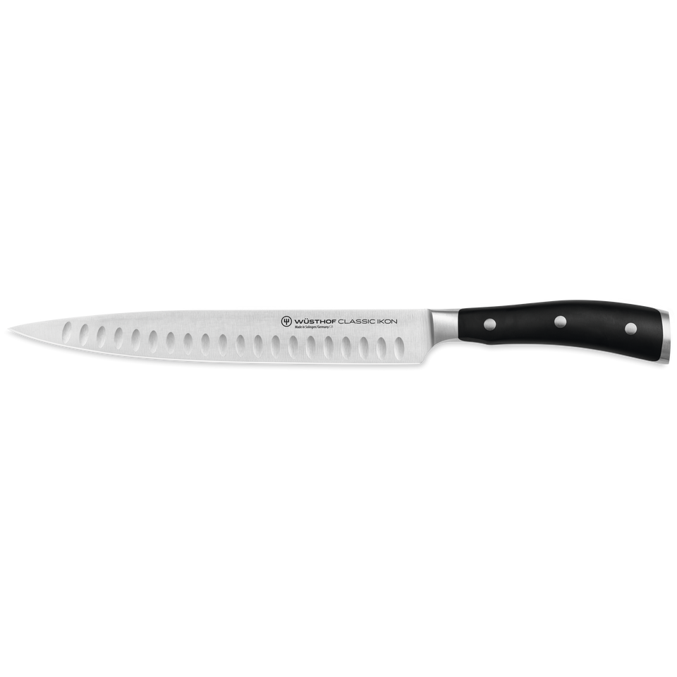 Classic Ikon 9" Hollow Edge Carving Knife with German-forged steel blade featuring hollow-ground indentations and a triple-riveted black ergonomic handle.