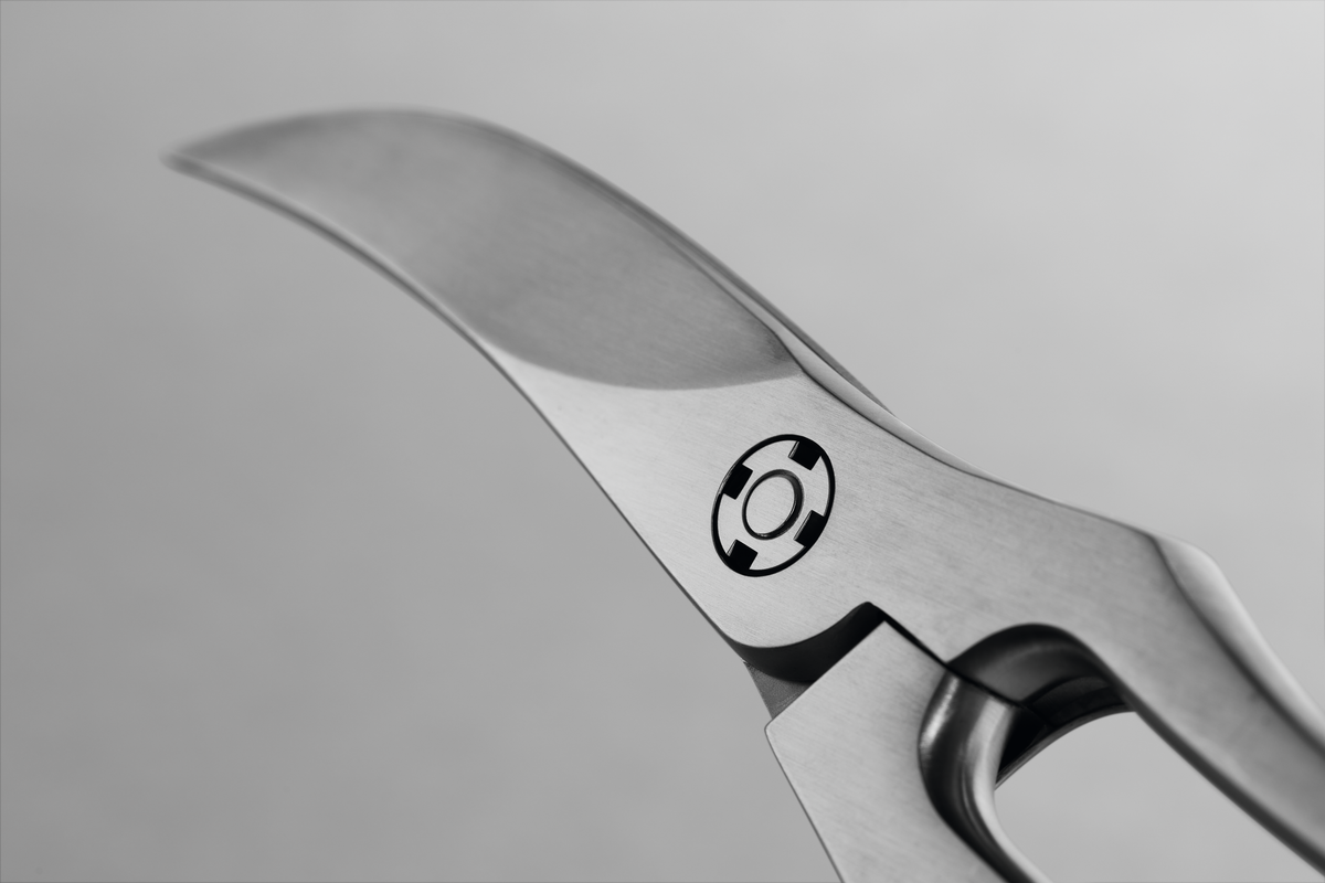 9" Stainless Steel Poultry Shears close-up showing the precision curved stainless steel blade and sturdy all-metal hinge mechanism.