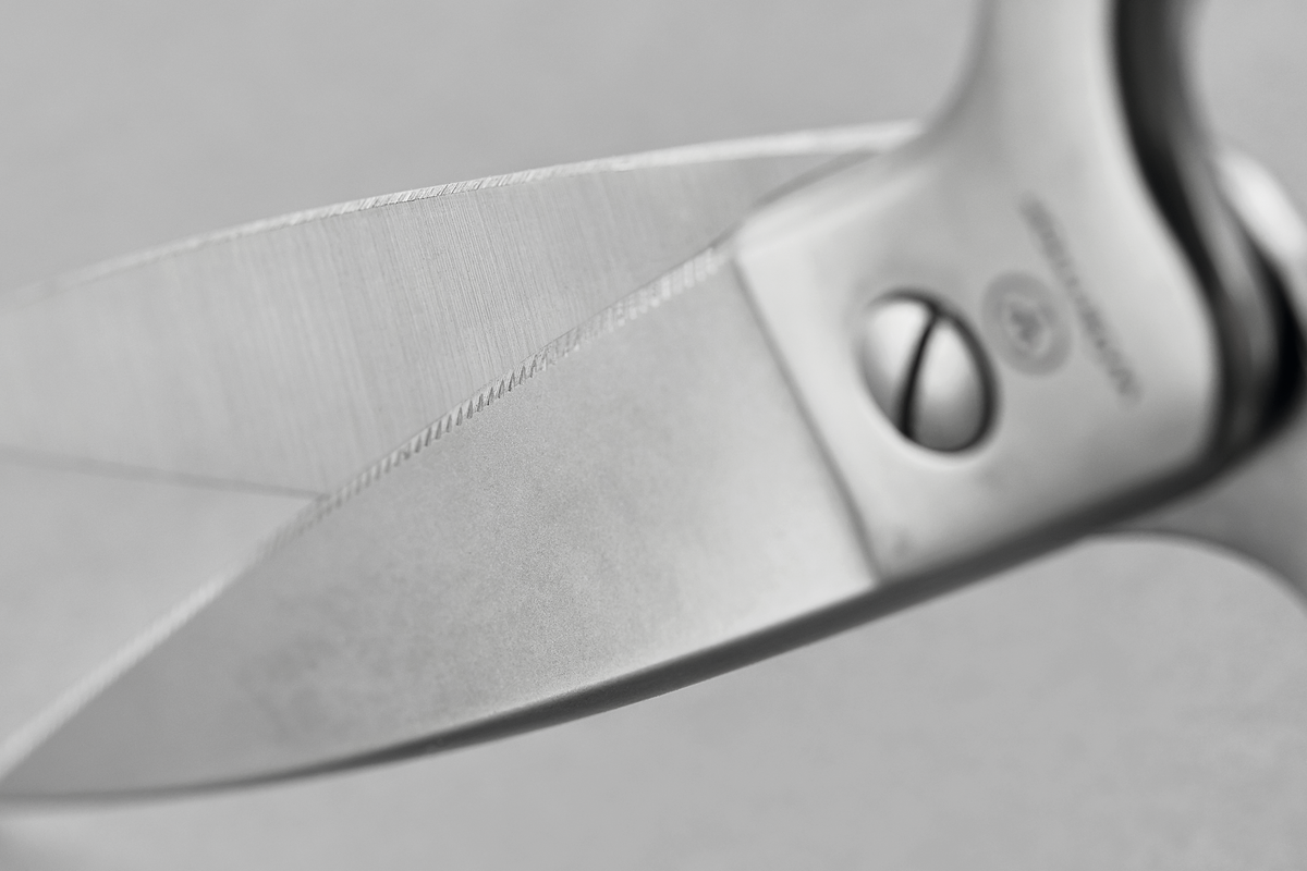 Stainless Kitchen Shears featuring precision-ground stainless steel blades with a serrated edge and secure rivet fastening for durable kitchen performance.