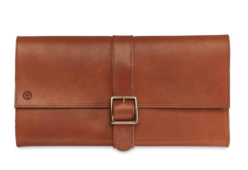 Ikon 6-Piece Mixed Wood Steak Knife Set with Leather Knife Roll folded into a smooth brown leather case featuring a stitched strap and buckle closure.