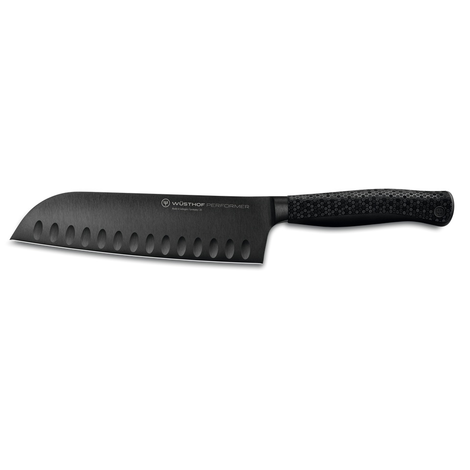 Performer 7" Santoku featuring a matte black forged German steel blade with hollow edge and textured ergonomic handle for precise cutting.