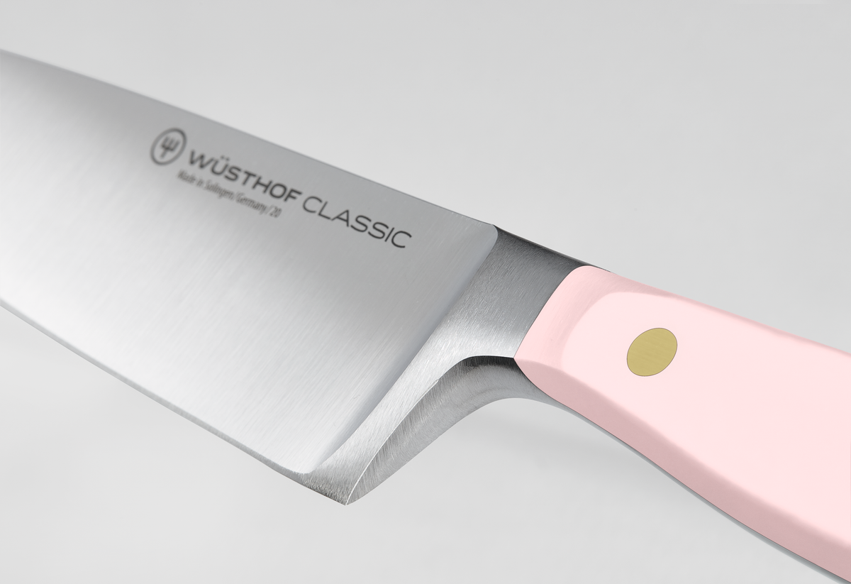Classic 8" Chef's Knife with a polished forged German steel blade and a soft pink synthetic handle featuring a brass rivet for a secure grip and precision.