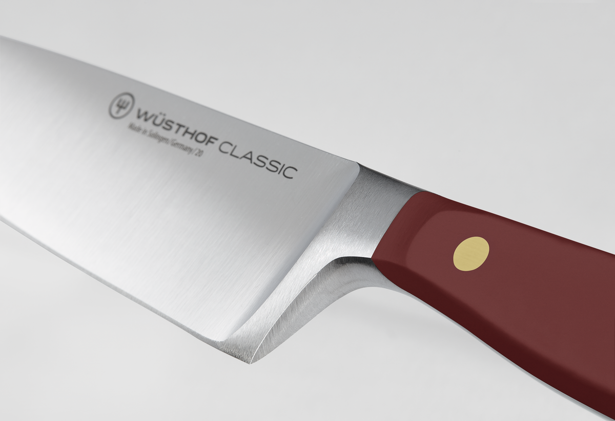 Classic 8" Chef's Knife featuring a forged German steel blade with a polished finish and a deep red handle secured by a brass rivet for durability and control.