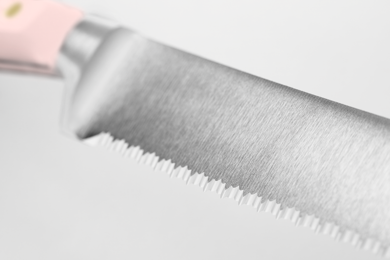 Classic 9" Precision Double-Serrated Bread Knife with a finely honed serrated blade and a pale pink ergonomic handle for comfortable grip and precise slicing.