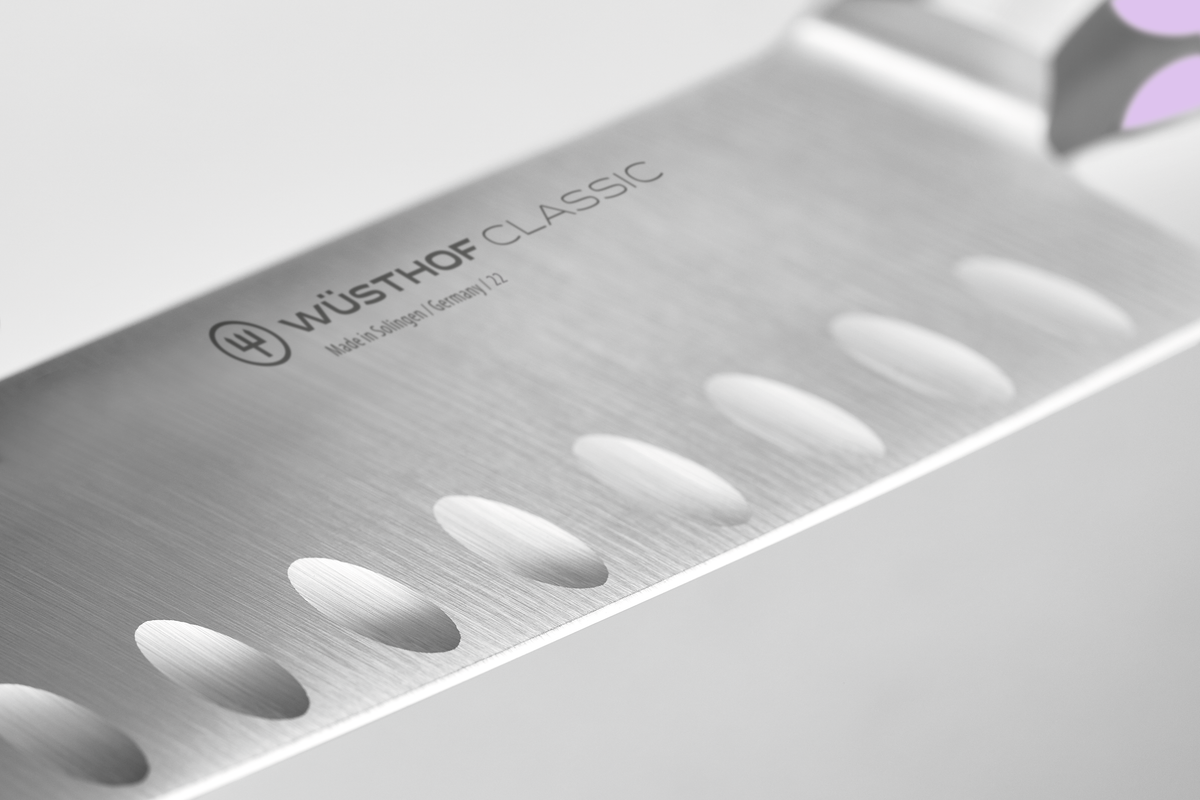 Classic 7" Hollow Edge Santoku with forged German steel featuring scalloped indentations to minimize food sticking for clean, efficient slicing.