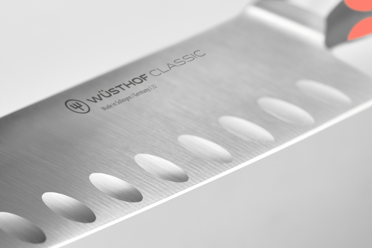 Classic 7" Hollow Edge Santoku featuring a forged German stainless steel blade with scalloped indentations to reduce food sticking and enhance slicing.