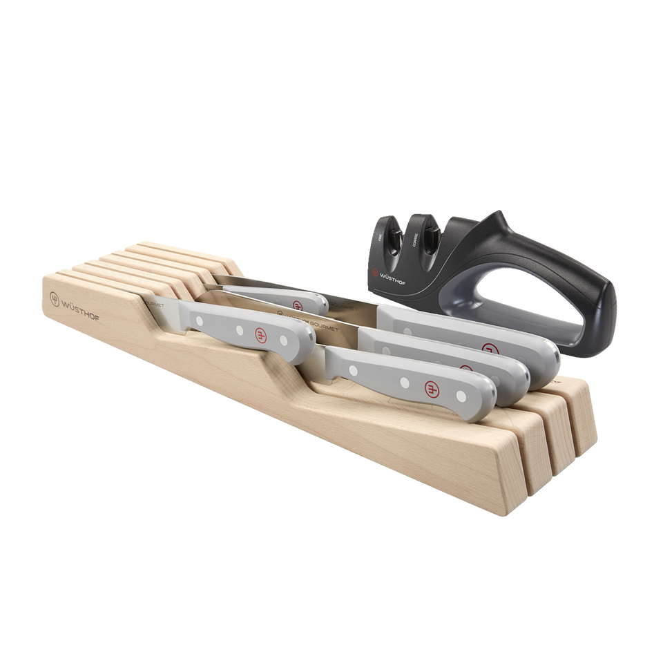 Gourmet 7-Piece In-Drawer Knife Set featuring forged German knives with gray ergonomic handles and polished rivets, plus a black dual-stage sharpener.