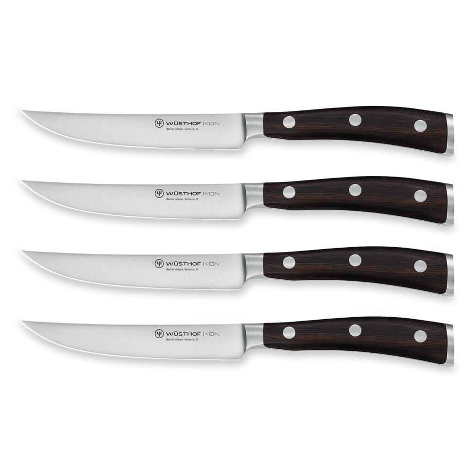 Ikon 4-Piece Steak Knife Set with forged German stainless steel blades and dark triple-riveted wooden handles, designed for precision steak cutting.