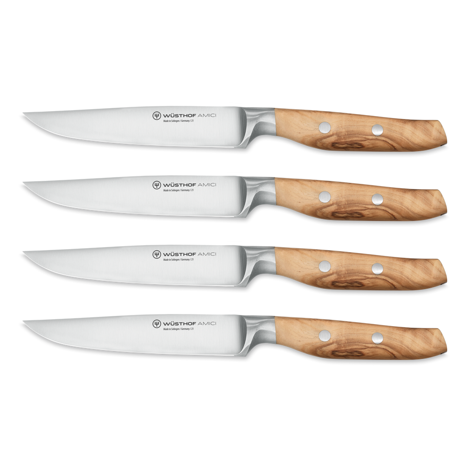 Four Amici 4 1/2" Steak Knives with polished stainless steel blades and smooth olive wood handles secured by three metal rivets.
