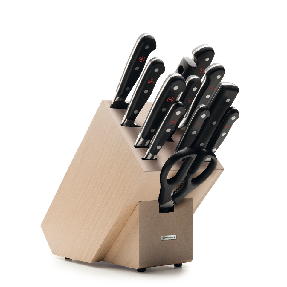 Classic 13-Piece Knife Block Set featuring a light wood block with forged German kitchen knives, ergonomic black handles, and included kitchen scissors.