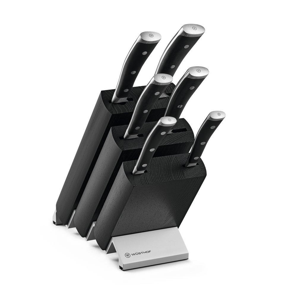 Classic Ikon 7-Piece Knife Block Set featuring forged German steel knives with triple-riveted black handles in a sleek black wooden block with metal logo plate.