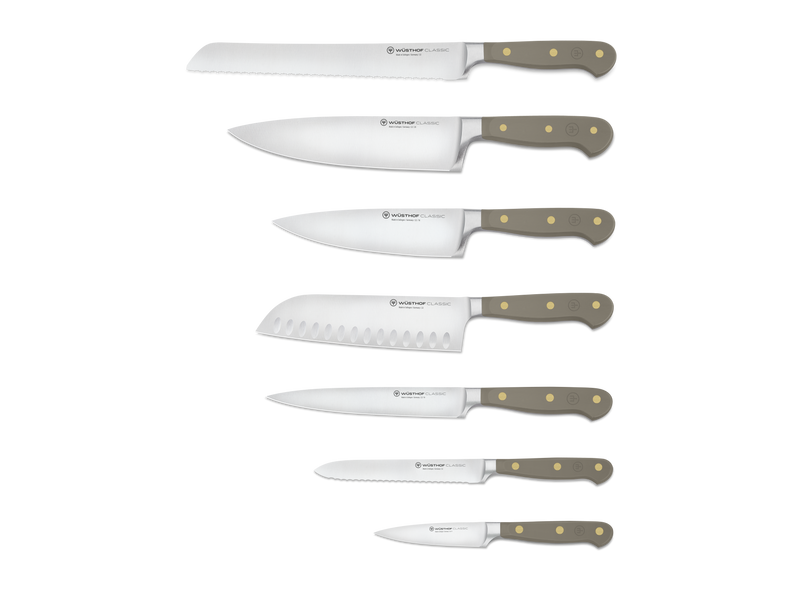 Classic 8-Piece Designer Knife Block Set featuring six forged German steel knives with smooth taupe ergonomic handles and brass rivets, including serrated and chef’s knives.