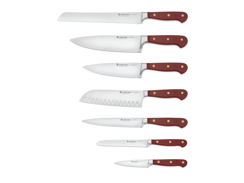 Classic 8-Piece Designer Knife Block Set displaying six forged German steel knives with rich red ergonomic handles and brass rivets, ideal for chefs.