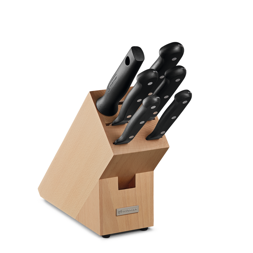 Gourmet 7-Piece Knife Block Set featuring forged German steel blades with ergonomic black triple-riveted handles in a natural wood block for organized kitchen storage.