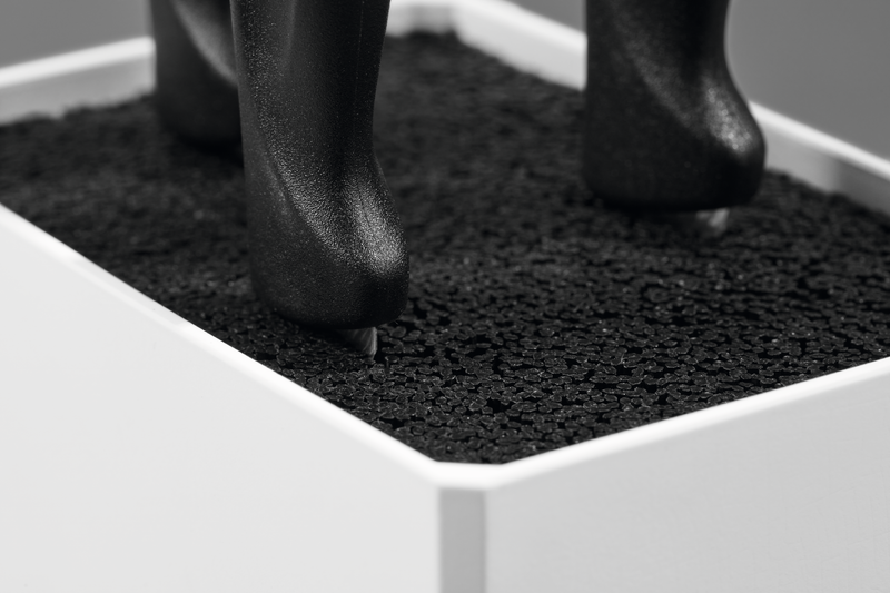Close-up of textured black insert inside the Create Knife Block’s sleek white frame, designed to securely hold kitchen knives with ergonomic handles.