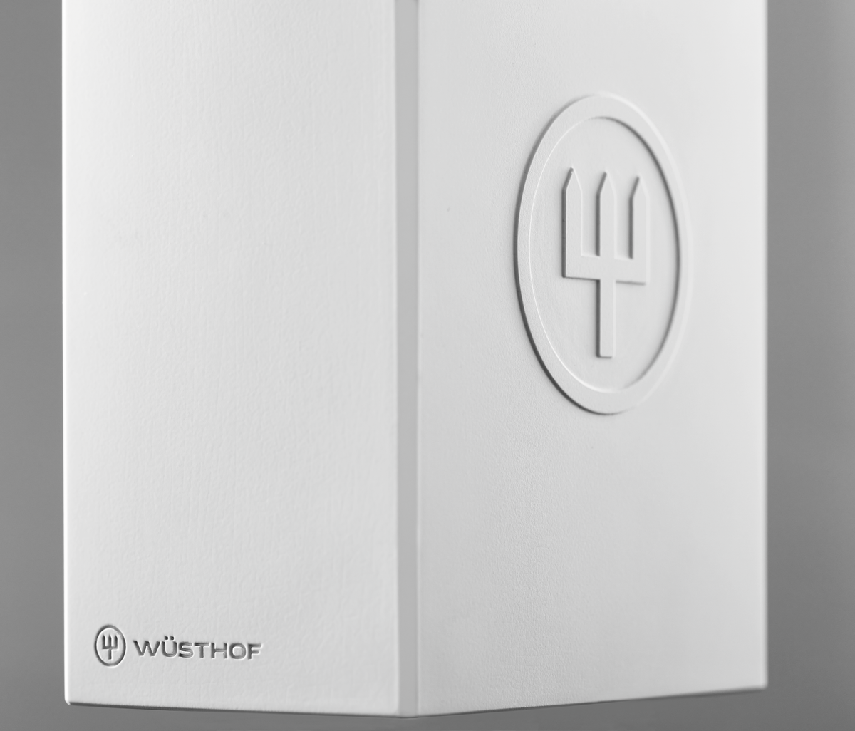 Create Knife Block close-up showcasing a smooth white surface with an embossed WÜSTHOF logo and clean minimalist design details.