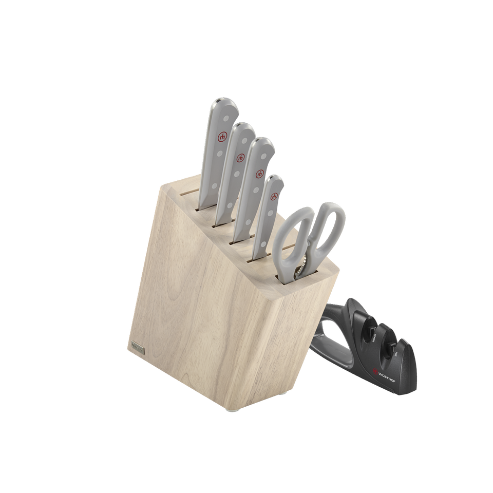 Gourmet 7-Piece Block Set featuring forged German kitchen knives with polished rivets, ergonomic gray handles, kitchen shears, and a black knife sharpener.