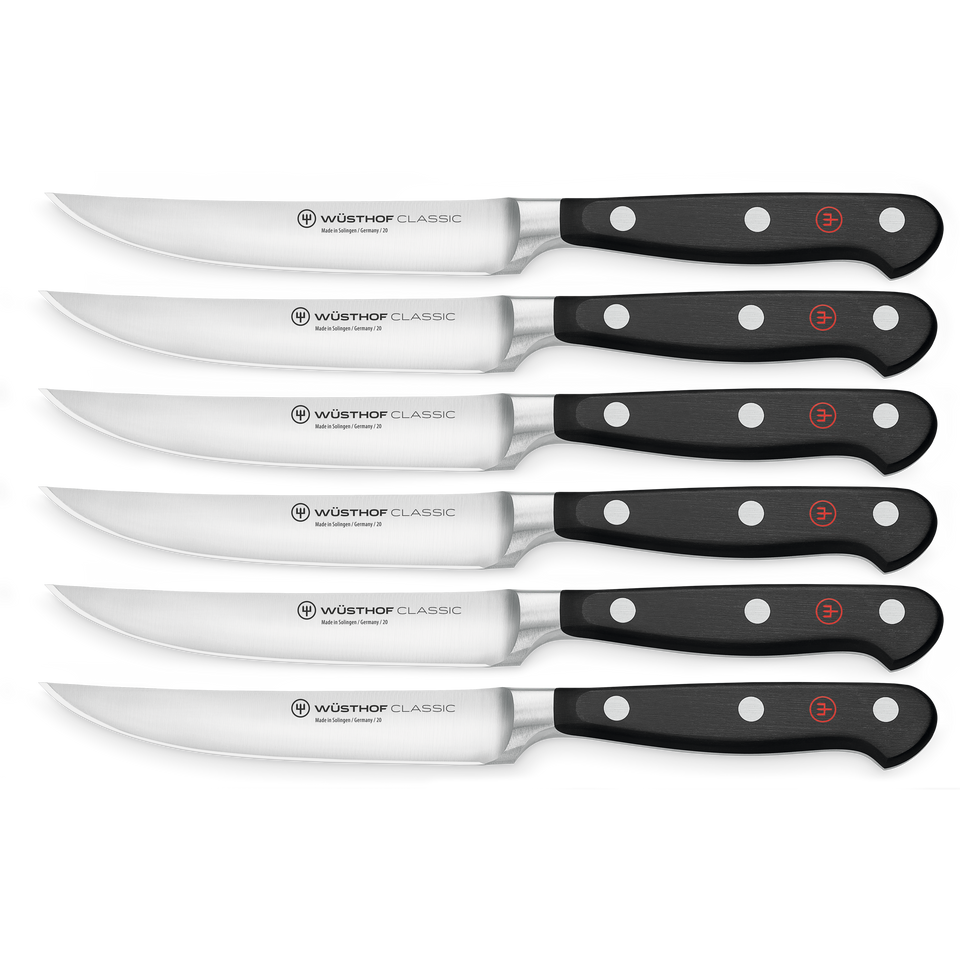 Classic 6-Piece Steak Knife Set with polished stainless steel blades and black triple-riveted handles featuring the WÜSTHOF logo on each handle end.