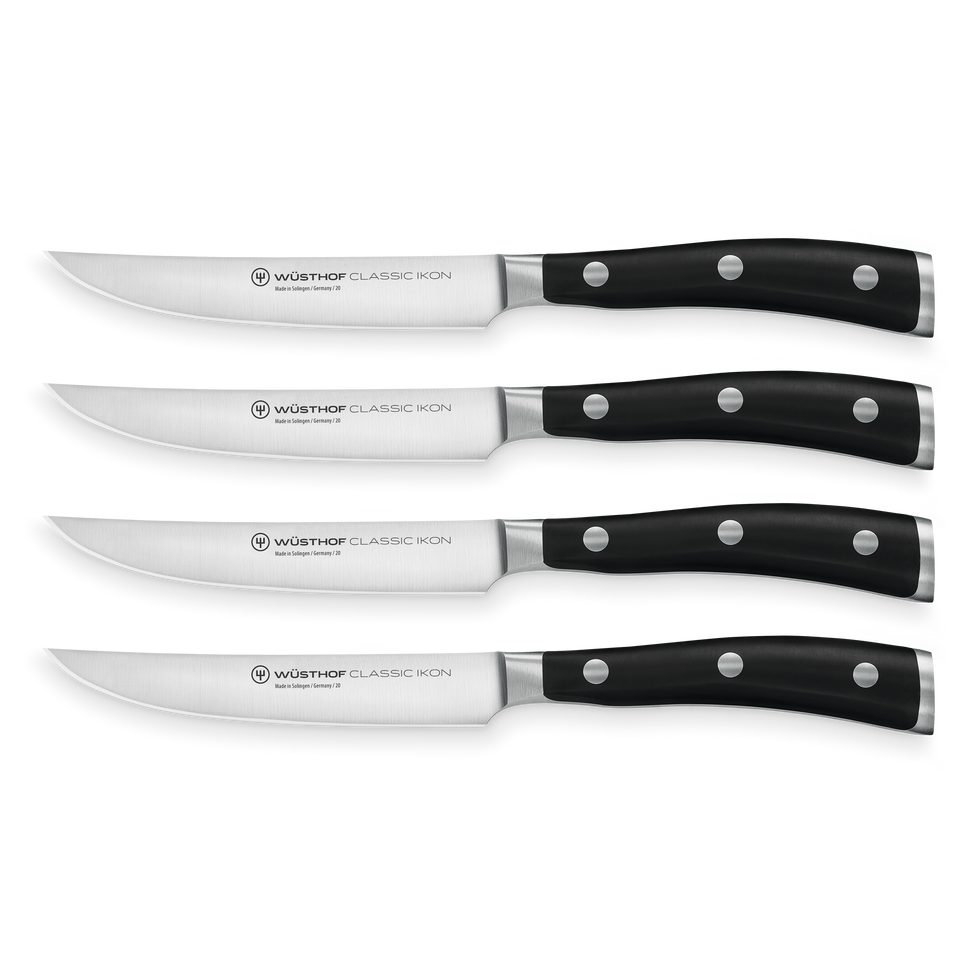 Classic Ikon 4-Piece Steak Knife Set with forged German steel blades and triple-riveted black ergonomic handles for precise and comfortable cutting.