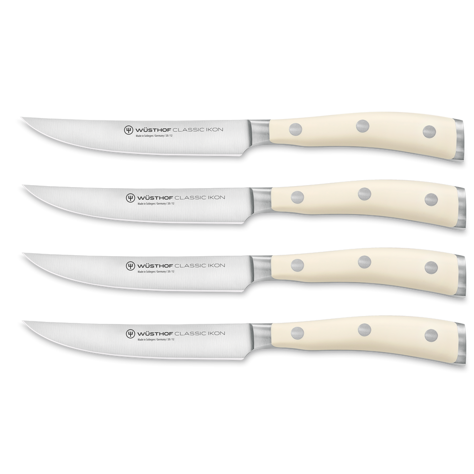 Classic Ikon 4-Piece Steak Knife Set featuring forged German steel blades with cream-colored triple-riveted handles for balanced cutting performance.