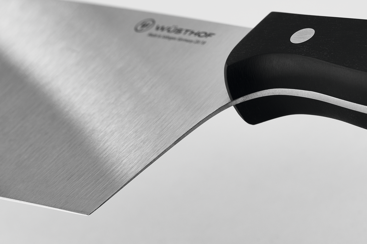 7" Chinese Chef's Knife with a sharp, forged stainless steel blade and ergonomic black handle featuring a single rivet for balanced grip and control.