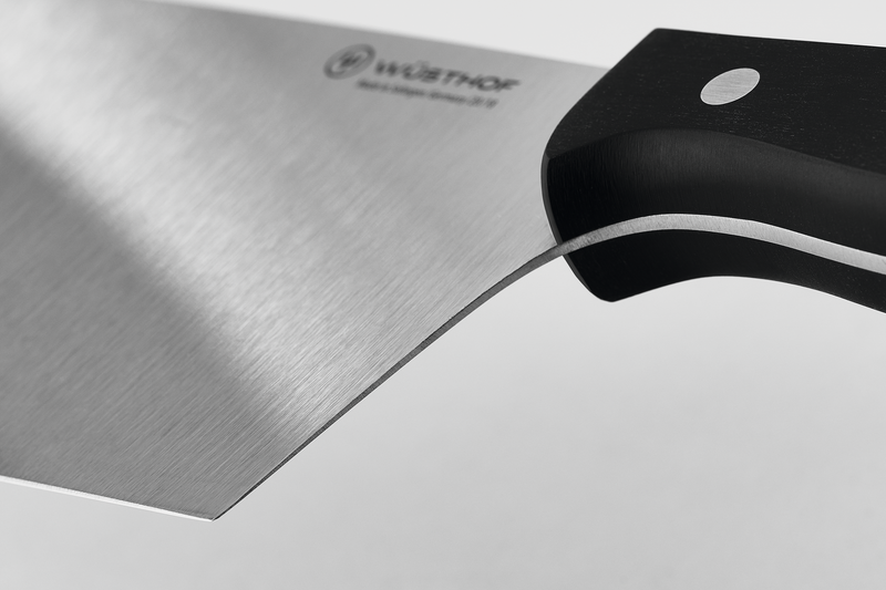 7" Chinese Chef's Knife with a sharp, forged stainless steel blade and ergonomic black handle featuring a single rivet for balanced grip and control.